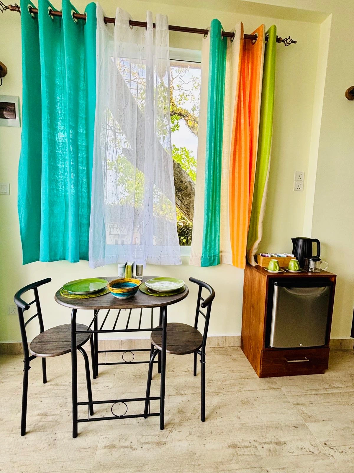 Bedroom with colorful Sri Lankan flag-themed bedding