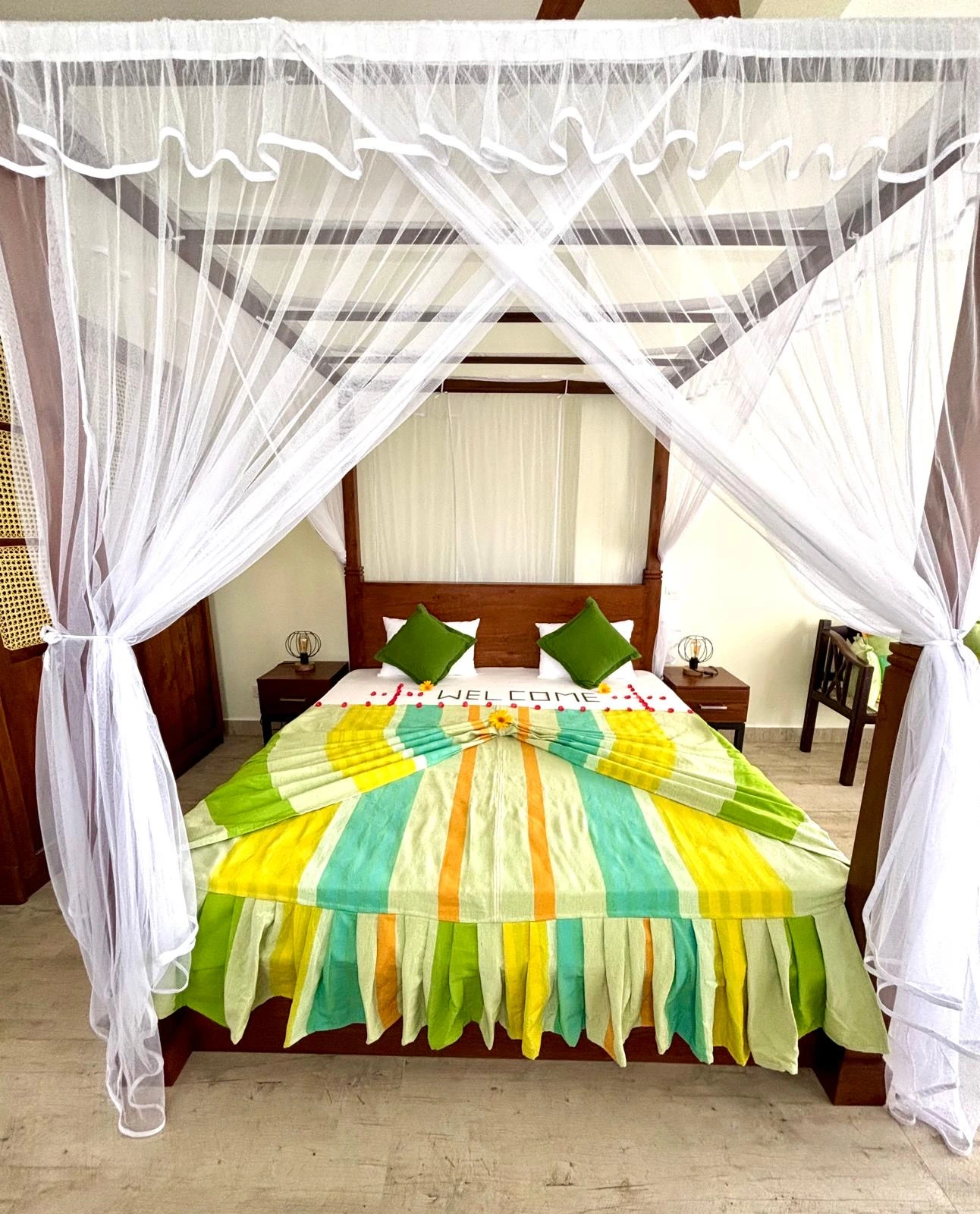 Bedroom with colorful Sri Lankan flag-themed bedding