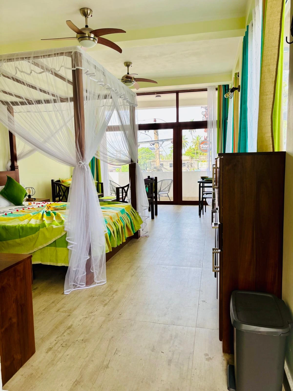 Bedroom with colorful Sri Lankan flag-themed bedding
